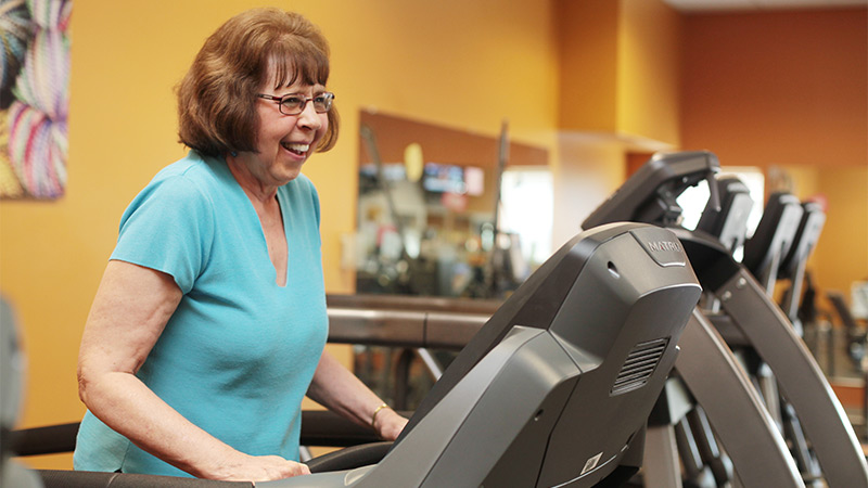 Indoor photo of a senior woman on treadmill